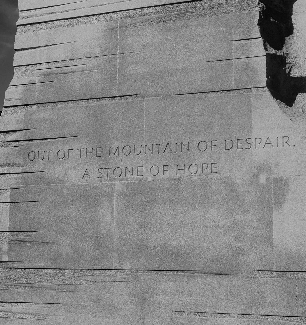 The carved inscription reading out of the mountain of despair, a stone of hope, in black and white