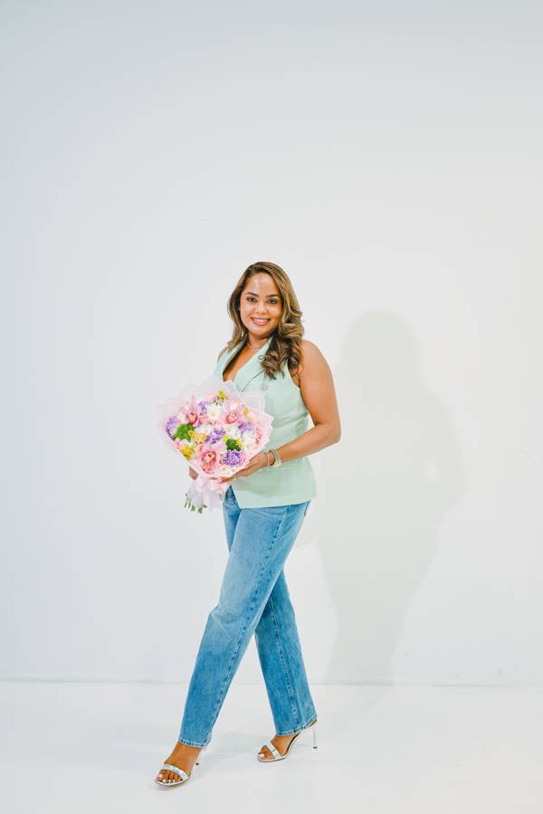 Elegant studio portrait of Danielle's mother holding a bouquet