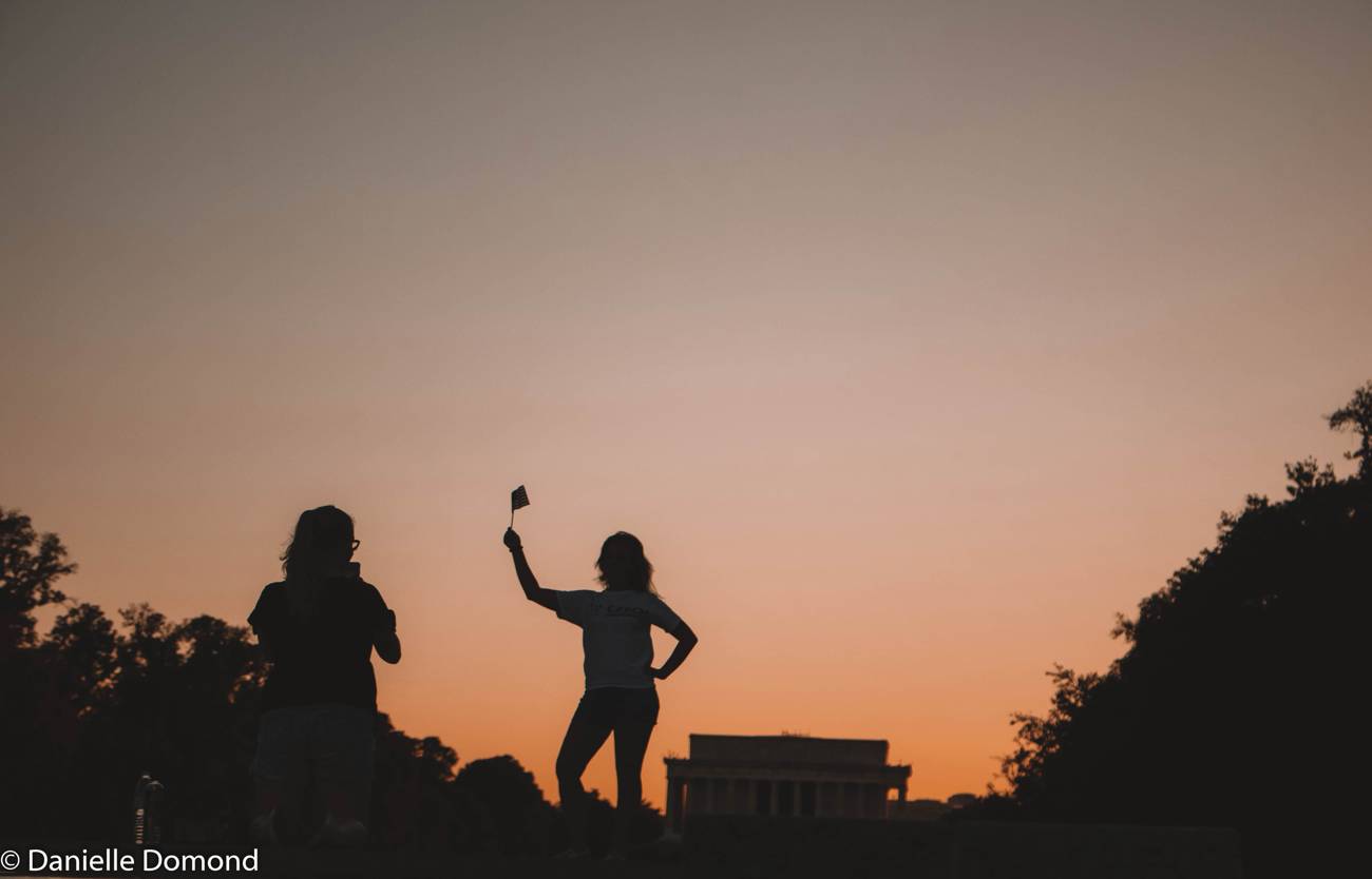 Silhouettes dancing at golden hour on the National Mall in Washington DC