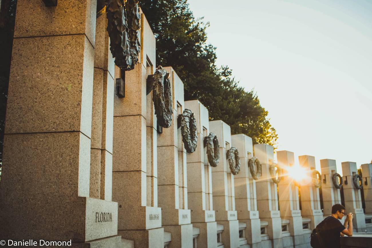 Memorial wreaths at the World War II Memorial at sunset
