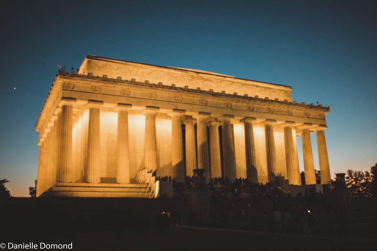 The Lincoln Memorial lit up against a deep blue night sky