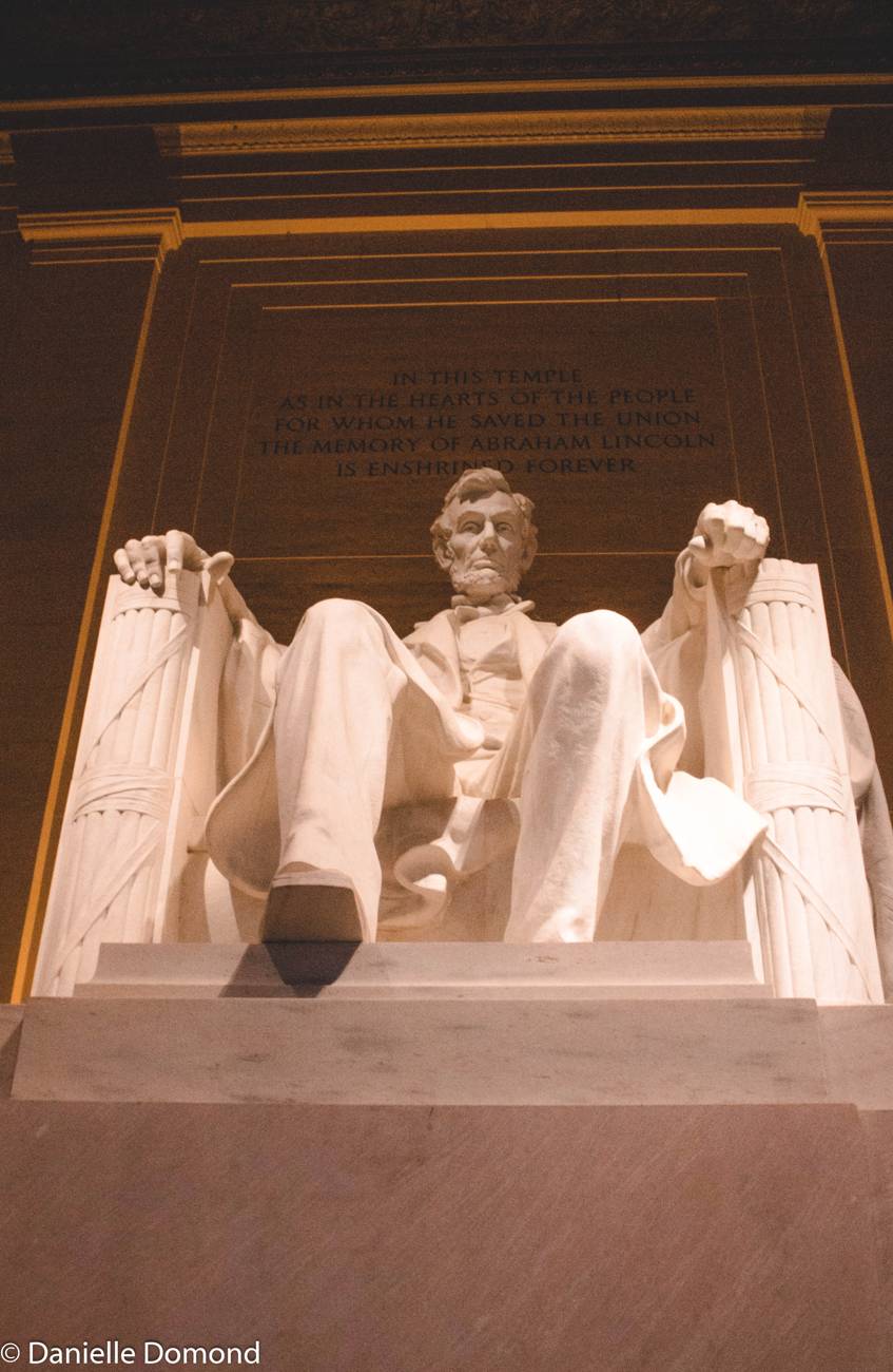 The Lincoln statue inside the memorial, glowing warm
