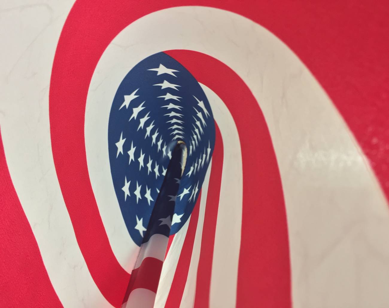 Looking through a spiraling American flag pinwheel, stars swirling toward the center