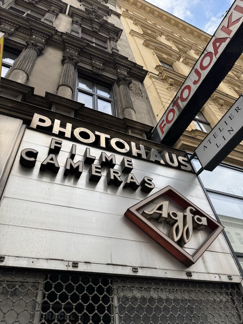 A vintage Photohaus storefront sign advertising film and cameras on a European street