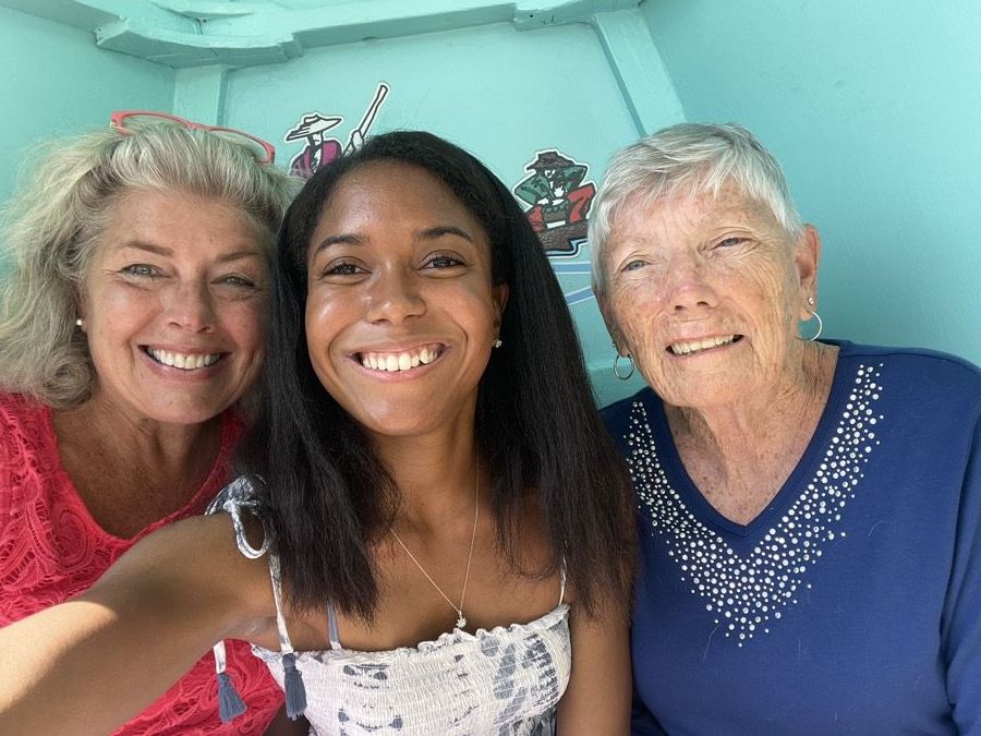 Danielle between her two mentors, Cynthia Schector on the left and Bernadette Wright on the right, all three smiling