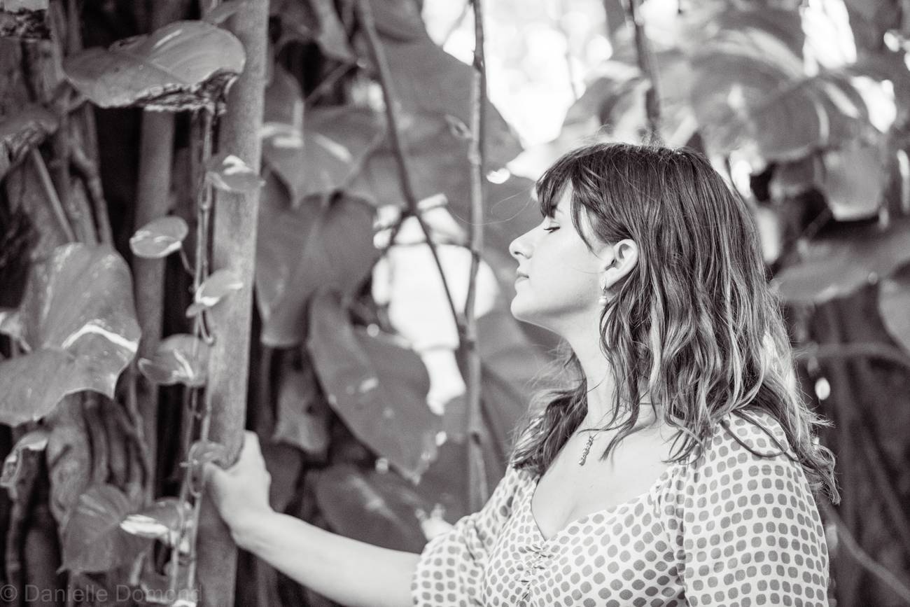 Annalise among broad leaves, in black and white