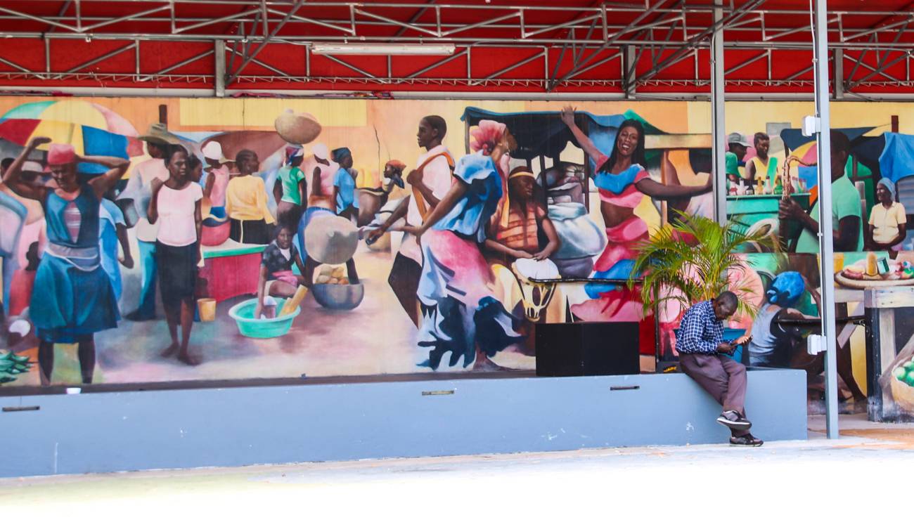 A vibrant Caribbean market scene artwork on display