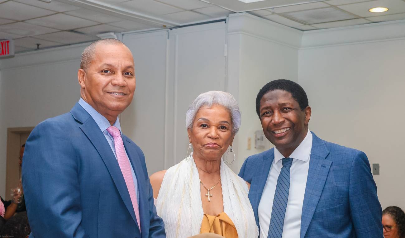 Three guests smiling together before an awards ceremony