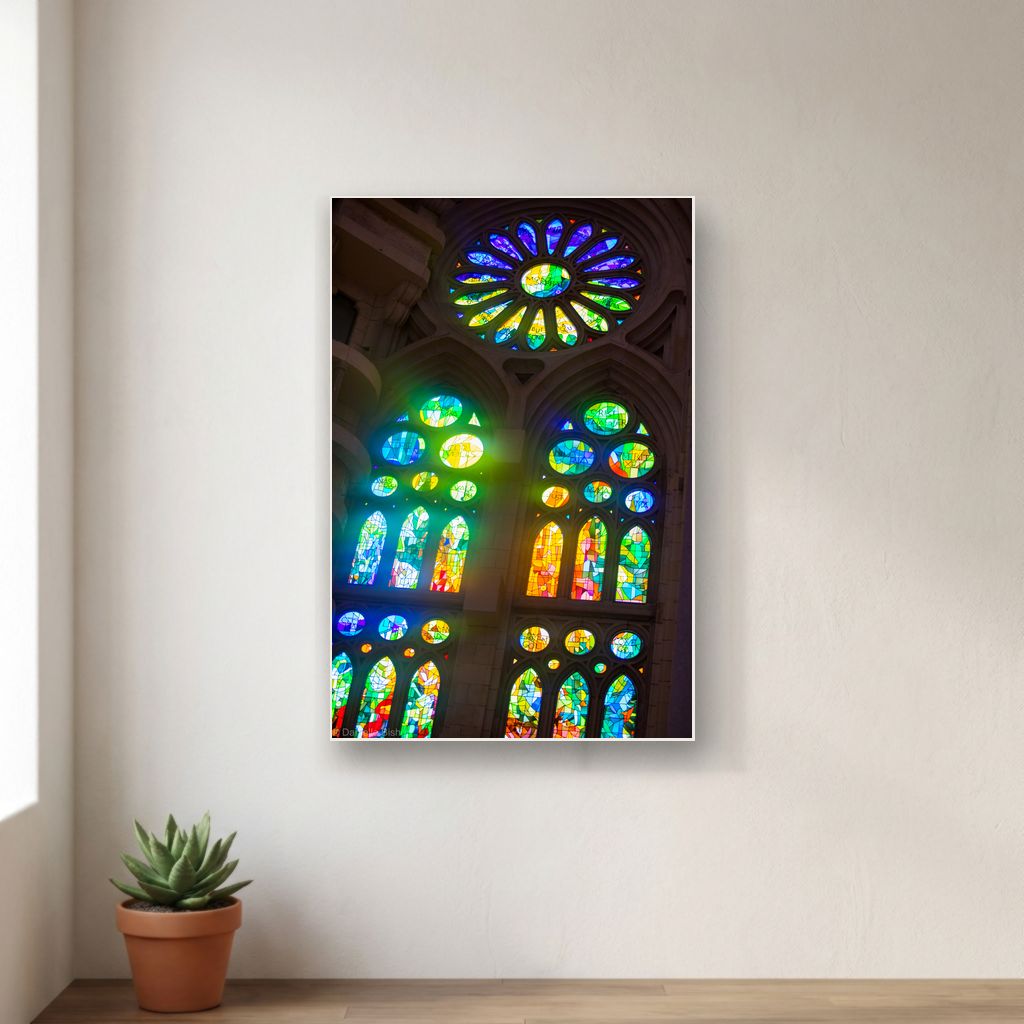 Canvas print mockup of stained glass windows glowing inside the Sagrada Familia, hanging on a clean wall