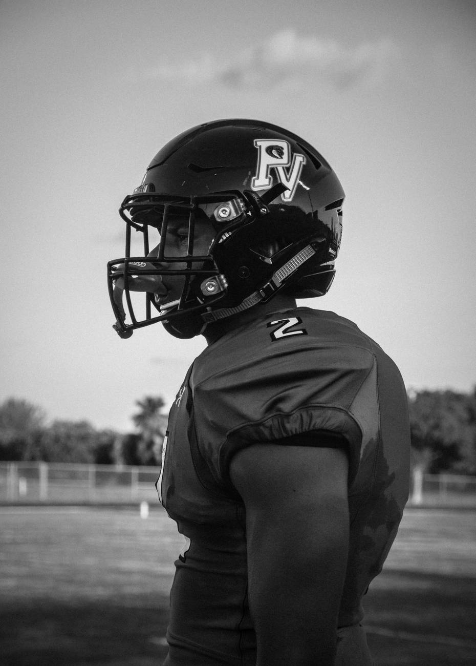 A black and white profile portrait of Park Vista football player number 2 in his helmet and pads