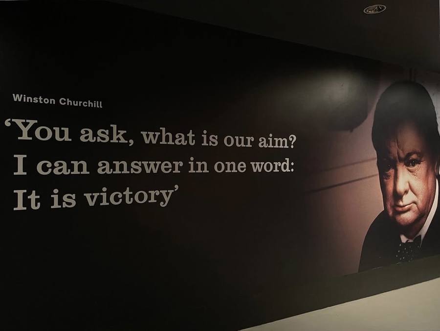 A quote wall at the Imperial War Museum in London reading, you ask what is our aim, I can answer in one word, it is victory, beside a portrait of Winston Churchill