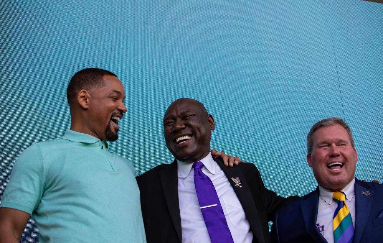 Will Smith, Ben Crump, and St. Thomas University President David A. Armstrong laughing together on stage
